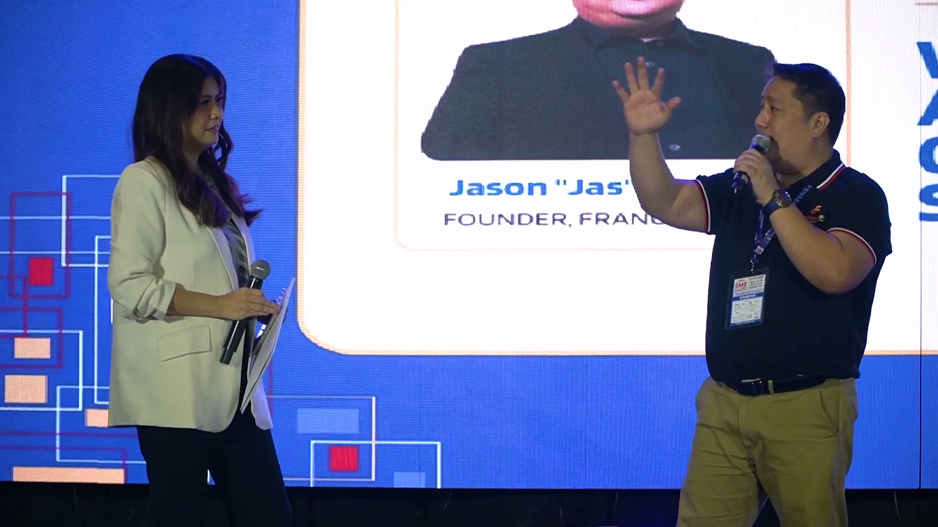 Jas Barinaga answering questions from the host on the PHILSME Business Expo stage.