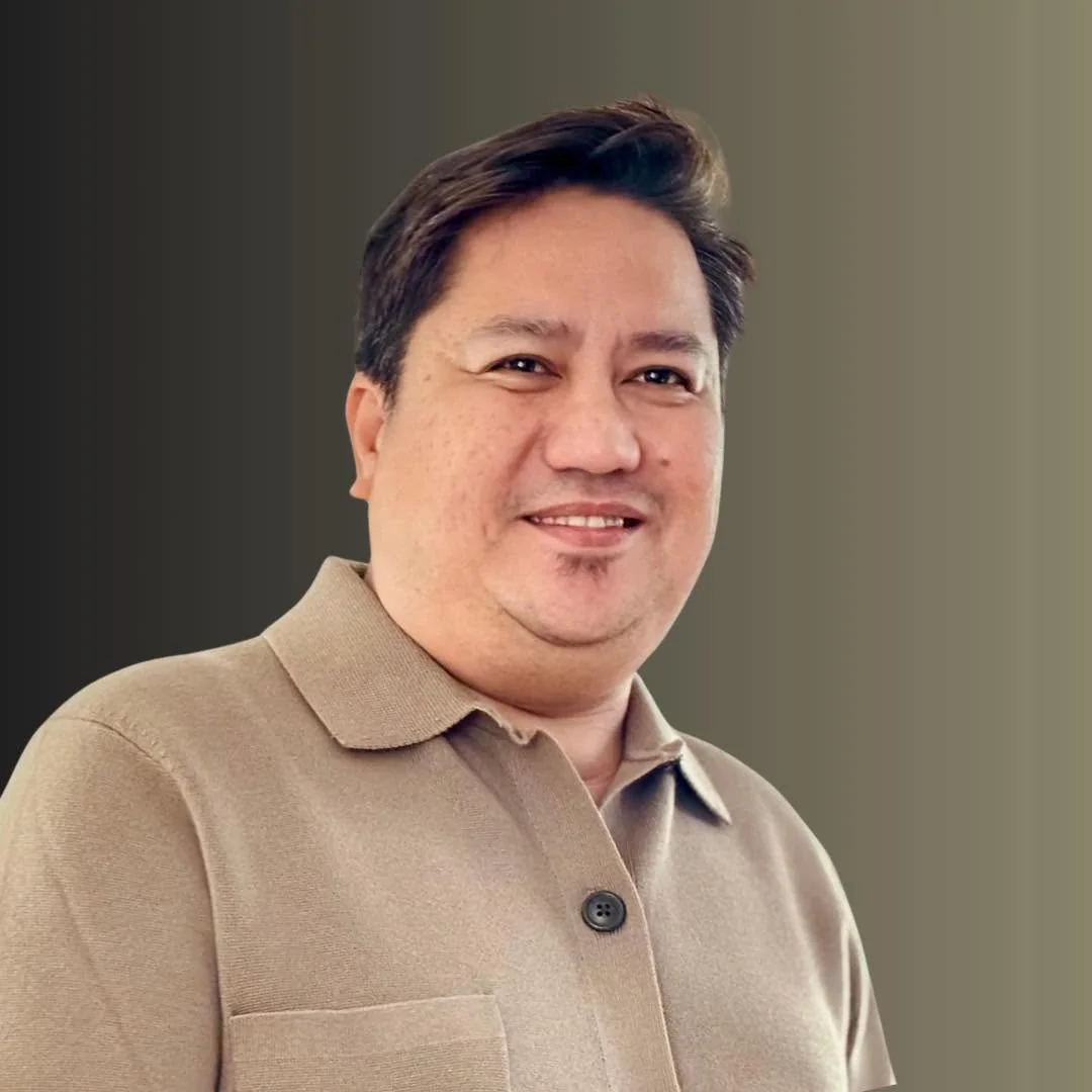 Jas Barinaga in a tan polo shirt.